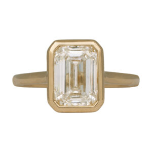 yellow gold solitaire engagement ring set with an emerald cut diamond