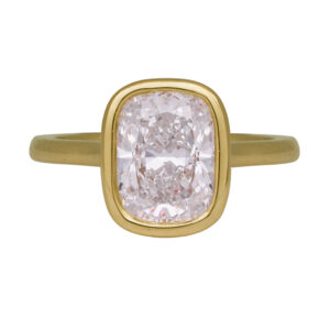 yellow gold solitaire engagement ring set with a cushion diamond