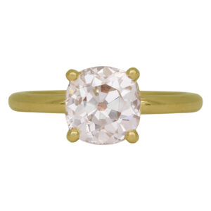 yellow gold solitaire engagement ring set with a cushion diamond