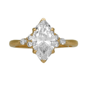 yellow gold ring centered with a marquise diamond flanked by round and marquise diamonds