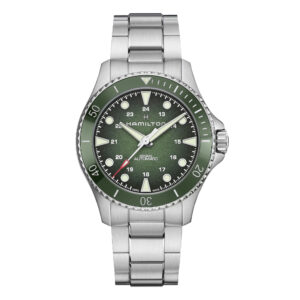 stainless steel watch with a deep green dial