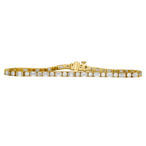 yellow gold tennis bracelet set with round and emerald cut diamonds