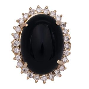 yellow gold halo ring centered with a large oval cabochon onyx surrounded by round diamonds