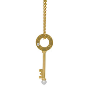 yellow gold pendant with a key set with a diamond and pearl