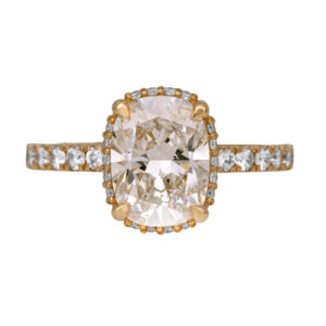 yellow gold engagement ring centered with a cushion diamond surrounded by round diamonds in the under-halo and band