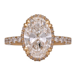 yellow gold under-halo engagement ring centered with an oval diamond surrounded by round diamonds in the under-halo and band