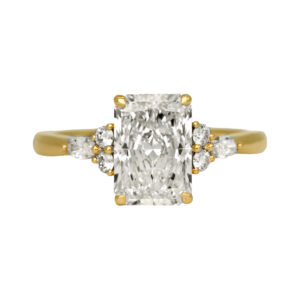 yellow gold engagement ring centered with a radiant diamond flanked by round and marquise diamonds