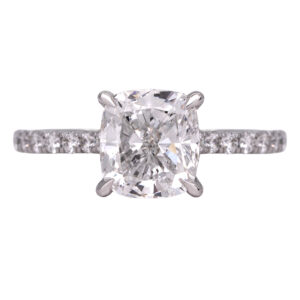 white gold under halo ring centered with a cushion diamond surrounded by round diamonds in the under-halo and band