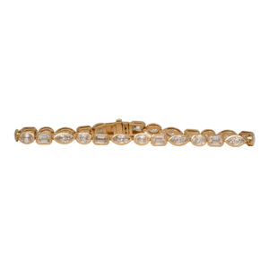 yellow gold tennis bracelet set with oval, emerald, and marquise diamonds