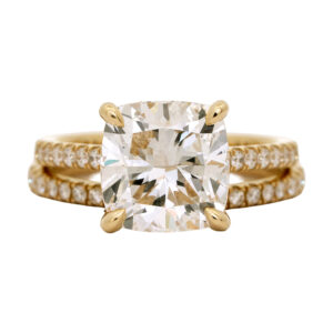 yellow gold engagement ring centered with a cushion diamond
