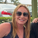 a bearded man smiling at the camera