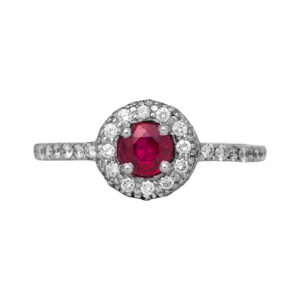 Vintage 14k white gold halo ring centered with a 0.25 carat round brilliant cut ruby surrounded by 0.50 carats of round brilliant earth-mined diamonds.