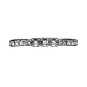 Antique platinum pierced clover milgrain bracelet set with 4.07 carats of old European cut earth-mined diamonds.