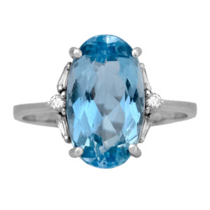 Vintage 18k white gold prong set ring set with a 4.02 carat oval cut aquamarine and 0.06 carats of round brilliant and baguette earth-mined diamonds.