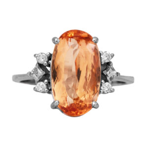 Vintage 18k white gold ring set with a 4.86 carat oval cut Imperial topaz plus 0.10 carats of round brilliant and princess cut earth-mined diamonds.