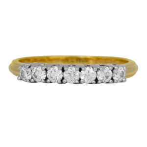 Vintage 18k yellow gold and platinum 7-stone band set with 0.42 carats of round brilliant earth-mined diamonds.