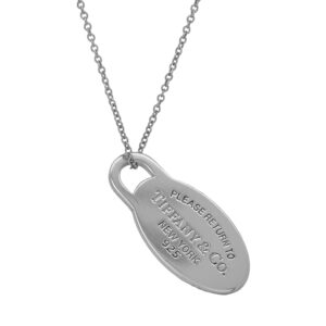 Vintage sterling silver Tiffany & Co. Please Return to Tiffany oval tag pendant on an 18-inch cable chain.