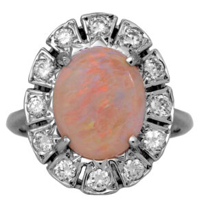 Vintage 14k white gold halo ring set with a 1.00 carat opal plus 0.60 carats of round brilliant earth-mined diamonds.