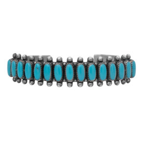 Vintage sterling silver cuff bracelet set with oval turquoise bezels.