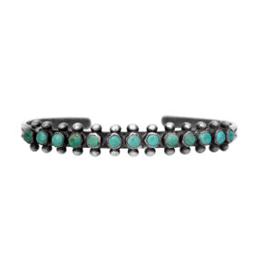 Vintage sterling silver cuff bracelet set with round turquoise bezels.