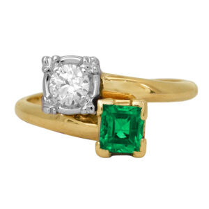 Vintage 14k yellow gold Toi et Moi ring set with a 0.51 carat emerald-cut emerald plus 0.26 carats of round brilliant diamonds.
