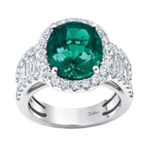 New 18k white gold Chatham halo ring set with a 4.56 carat oval cut lab-grown emerald plus 1.85 carats of baguette cut and round brilliant lab-grown diamonds.