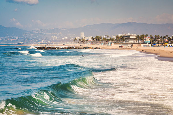 a image of the San Diego coastline with waves breaking at the beach