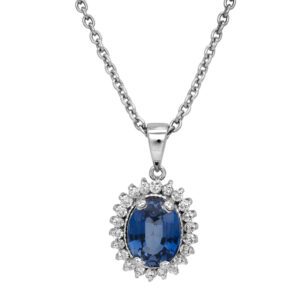 Vintage 18k white gold halo pendant set with a 1.89 carat oval blue sapphire plus 0.25 carats of round brilliant earth-mined diamonds.