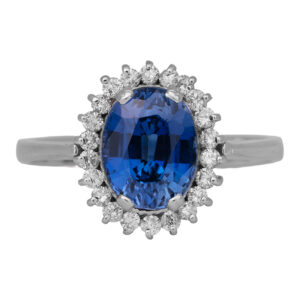 Vintage 18k white gold halo ring set with a 2.53 carat oval blue sapphire and 0.25 carats of round brilliant earth-mined diamonds.