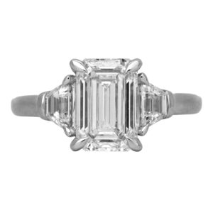 New 14k white gold 3-stone engagement ring set with a 3.01 carat emerald cut lab-grown diamond plus 0.57 carats of trapezoid cut lab-grown diamonds.