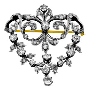 Antique platinum and 18k yellow gold brooch/pendant set with 3.65 carats of old European cut earth-mined diamonds.