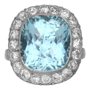 Antique platinum halo ring set with an 8.84 carat cushion aquamarine plus 1.60 carats of round brilliant earth-mined diamonds.