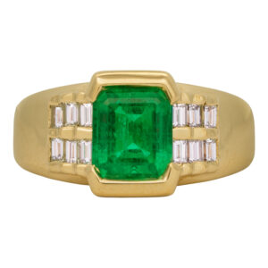 Vintage 18k yellow gold ring set with a 1.50 carat emerald cut emerald plus 0.50 carats of baguette earth-mined diamonds.