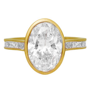 New 14k rose gold engagement ring set with a 4.13 carat oval lab-grown diamond plus 0.81 carats of round brilliant and baguette lab-grown diamonds in the band.