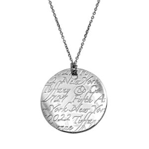 Vintage sterling silver Tiffany & Co. New York Notes disk pendant on an 18-inch cable chain.