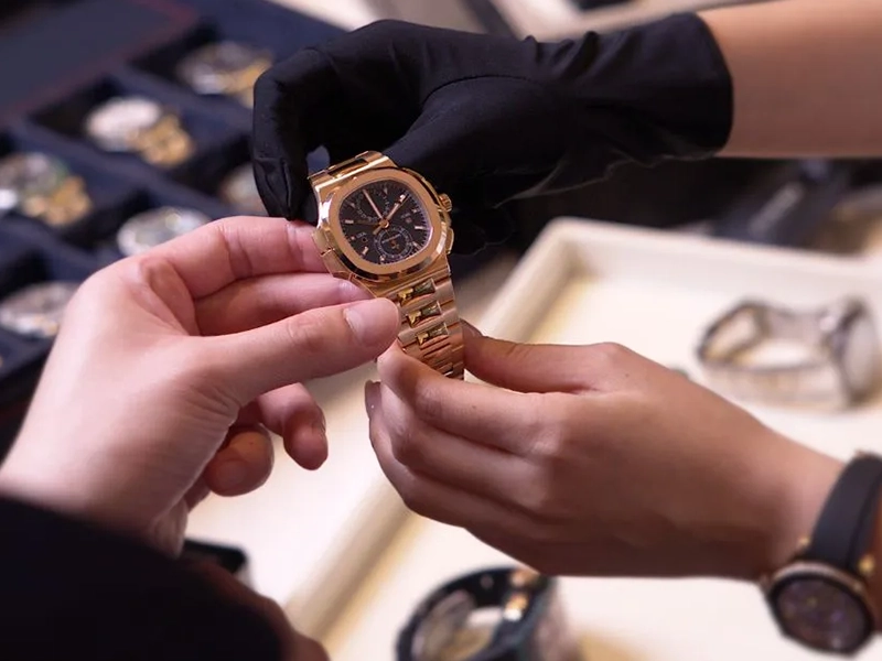 inspection of a luxury watch in a boutique setting