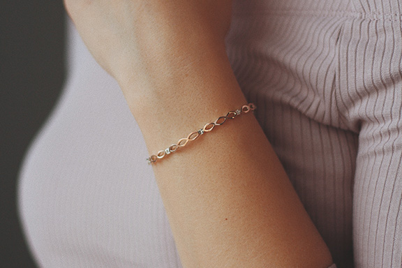 a close up image of a woman wearing a bangle on her wrist
