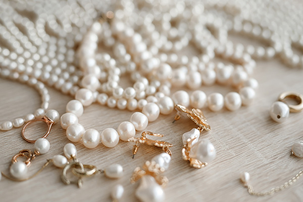 a close up image of numerous pearl strands on a countertop.