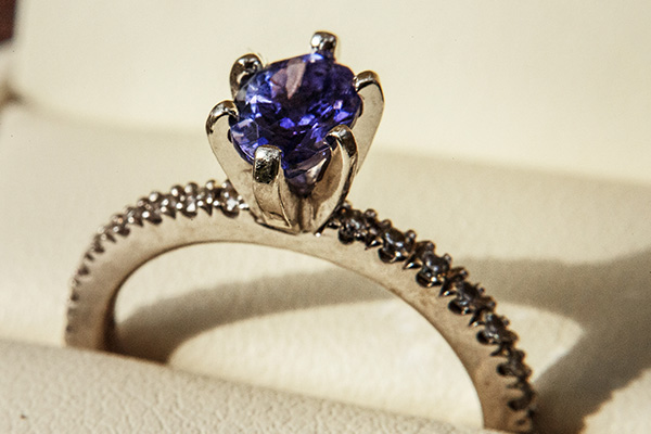 a close up image of a diamond and amethyst ring.