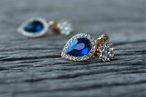 a close up image of sapphire and diamond earrings.