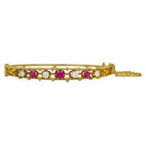 Vintage 14k yellow gold bangle set with 0.80 carats of round brilliant rubies and 1.00 carats of round brilliant earth-mined diamonds.