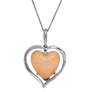 Vintage 18k white gold pendant set with a 17.20 carat heart Ethiopian opal plus 0.18 carats of round brilliant earth-mined diamonds.
