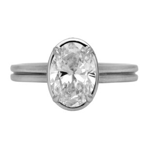 New 14k white gold outer halo engagement ring set with a 2.00 carat lab-grown oval diamond plus 0.24 carats of lab-grown round brilliant diamonds.