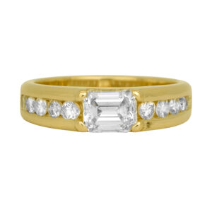 Vintage 14k yellow gold ring set with a 0.99 carat emerald cut earth-mined diamond plus 1.00 carat of round brilliant earth-mined diamonds.