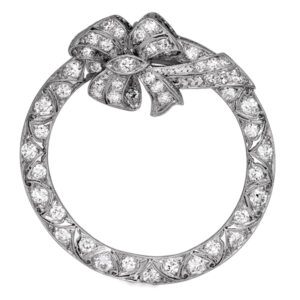 Antique platinum bow & circle pendant set with 1.31 carats of old European cut earth-mined diamonds.