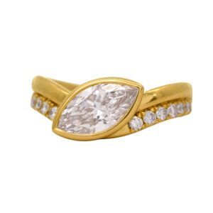 New 14k yellow gold East-West engagement ring set with a 1.50 carat marquise lab-grown diamond plus 0.34 carats of round brilliant lab-grown diamonds. In an "East-West" setting, the center diamond is set horizontally across the finger rather than the traditional "North-South" orientation. Especially effective for elongated shapes such as oval, marquise, and emerald cuts.