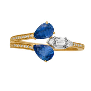 New 14k yellow gold bypass ring set with 1.14 carats of pear blue sapphires plus 0.22 carats of round brilliant and baguette cut earth-mined diamonds.