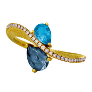 New 14k yellow gold bypass ring set with 1.40 carats of pear blue topaz plus 0.14 carats of round brilliant earth-mined diamonds.