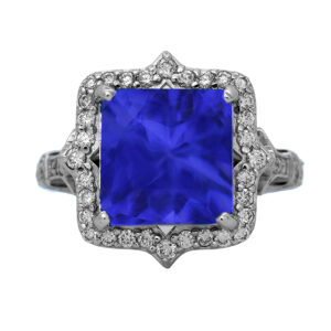 New 18k white gold halo ring set with a 4.45 carat princess tanzanite plus 0.60 carats of round brilliant earth-mined diamonds.