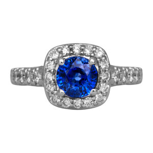 Vintage 14k white gold halo ring set with a 0.23 carat round brilliant blue sapphire plus 0.66 carats of round brilliant earth-mined diamonds.